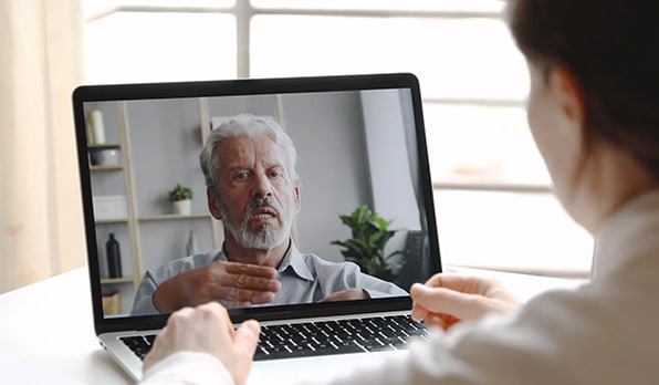 Female learner watching an on-demand course on her laptop