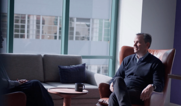 Hugo Sarrazin, CEO of Udemy, sitting down and chatting in front of a large window