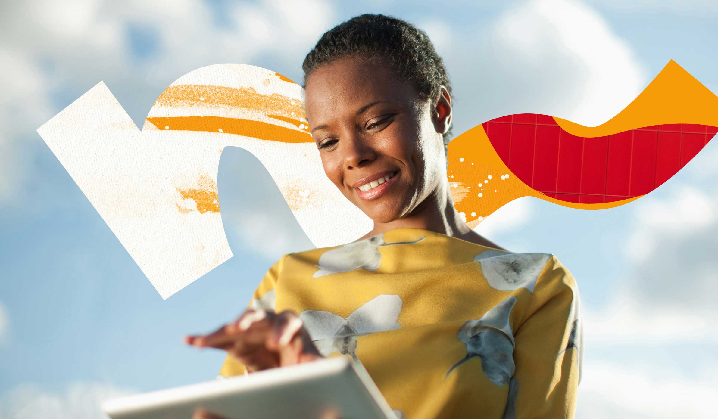 Smiling female employee in a yellow shirt interacting with her tablet's touch screen