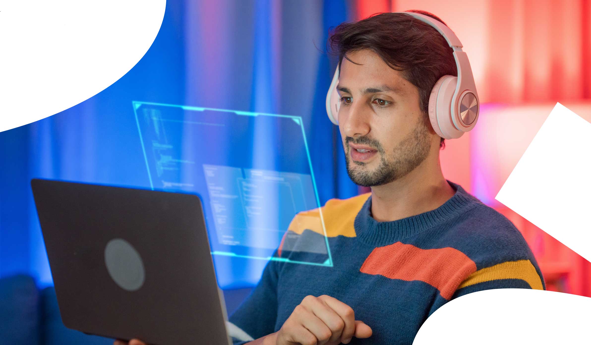 Man wearing big headphones and engaging with his laptop