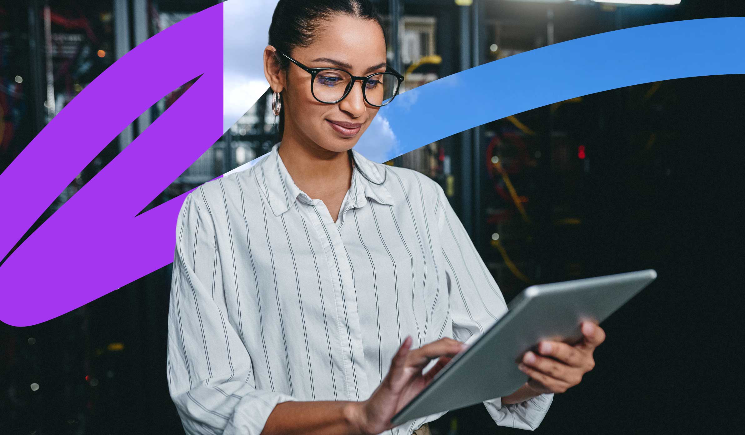 Female professional in business casual attire and glasses standing and working on her tablet