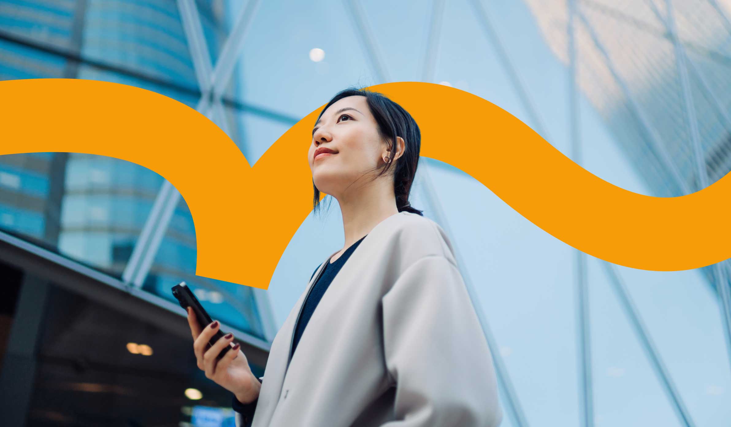 Female employee holding her phone and looking up into the air confidently
